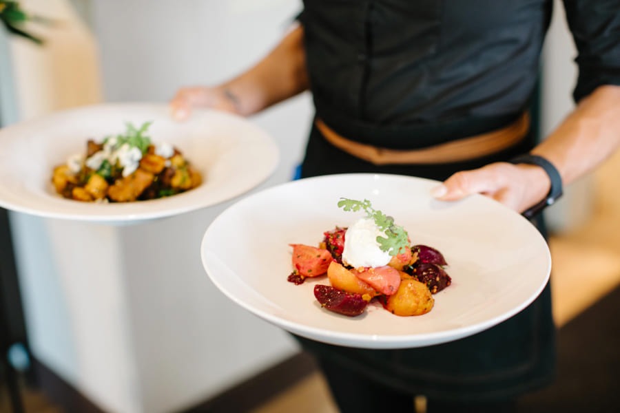 Waiter carrying two meals